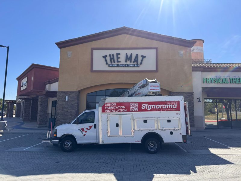 Signarama Temecula service truck on site during a storefront sign installation at The Mat
