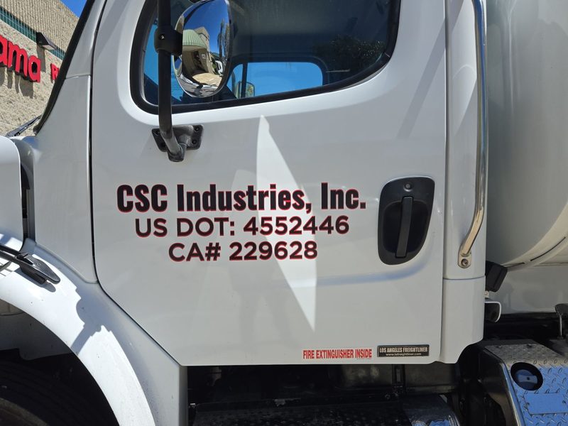 USDOT and CA carrier numbers lettered on a CSC Industries box truck door