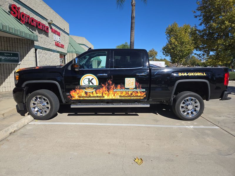Partial vehicle wrap with flame graphics on a Ghetto Kitchen pickup truck
