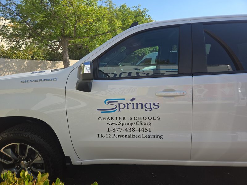 Cut vinyl door lettering on a Springs Charter Schools pickup truck