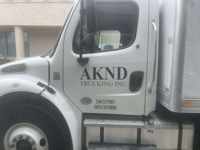 AKND Trucking box truck with company lettering and USDOT and CA carrier numbers
