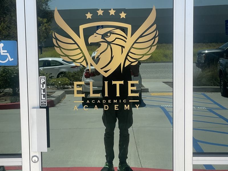 Gold vinyl logo applied to a glass entry door for Elite Academic Academy